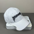 White cotton cap with black graphic embroidery and sculpted brim