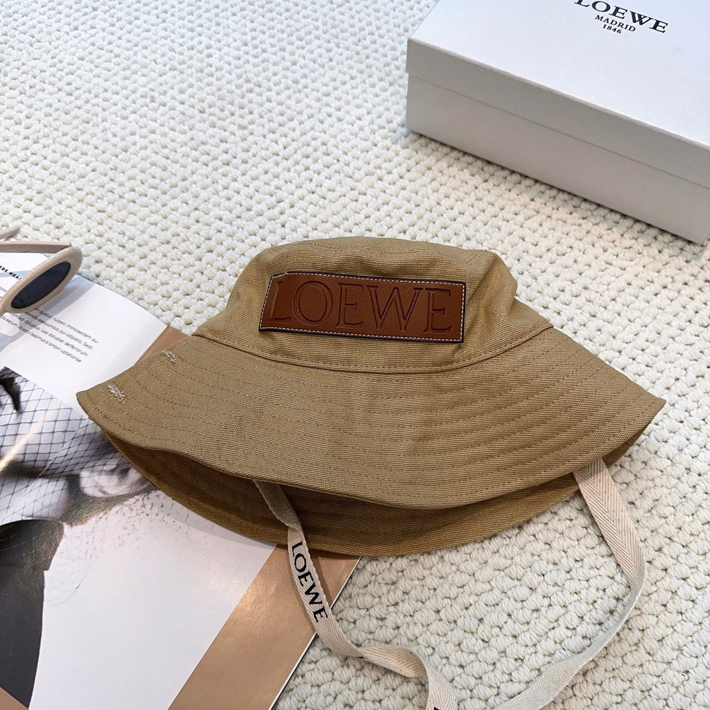 Soft canvas bucket hat with embossed leather logo patch and adjustable chin strap